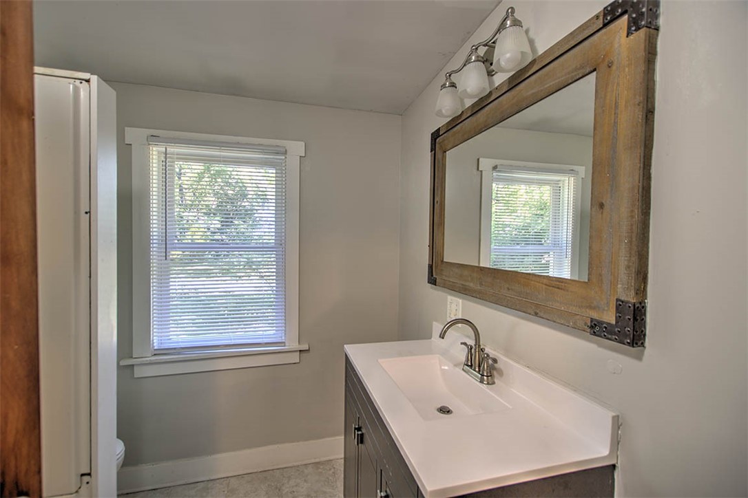 7450 West William Street Decatur, IL 62522 - Photo 10 of 18 a bathroom with a sink and a window