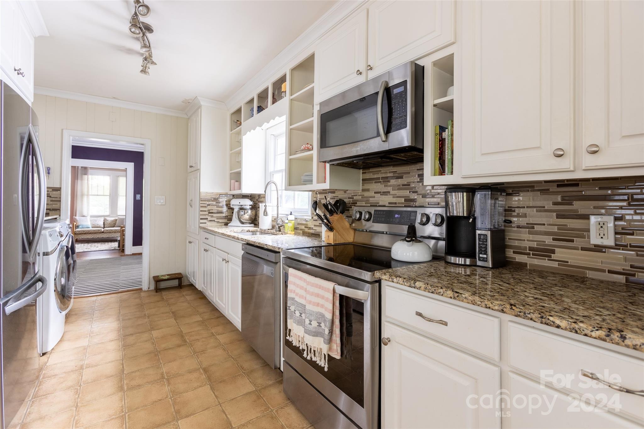 1624 Club Road Charlotte, NC 28205 - Photo 11 of 23 a kitchen with stainless steel appliances granite countertop a stove sink and cabinets
