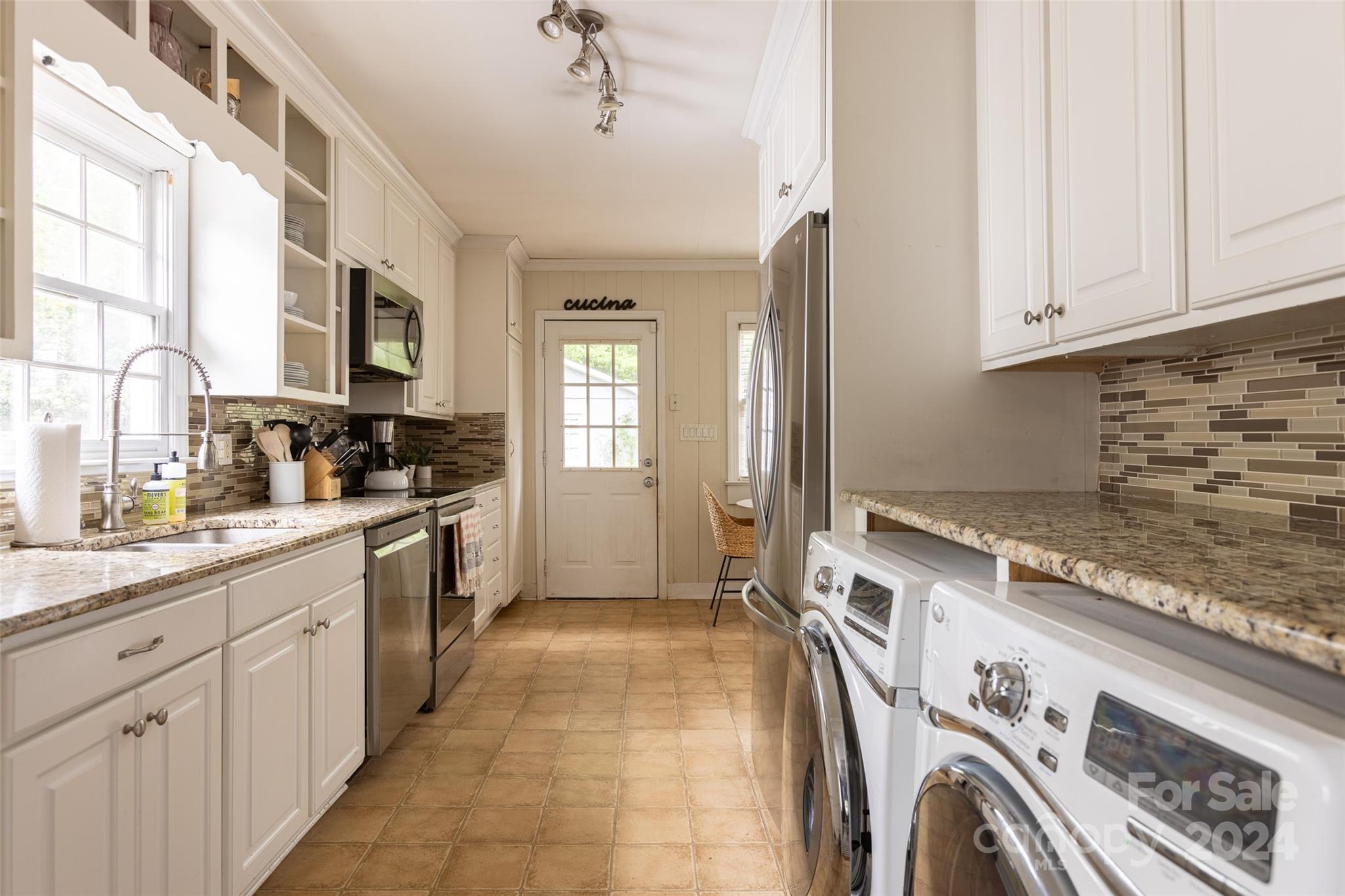 1624 Club Road Charlotte, NC 28205 - Photo 9 of 23 a kitchen with a sink stove and cabinets