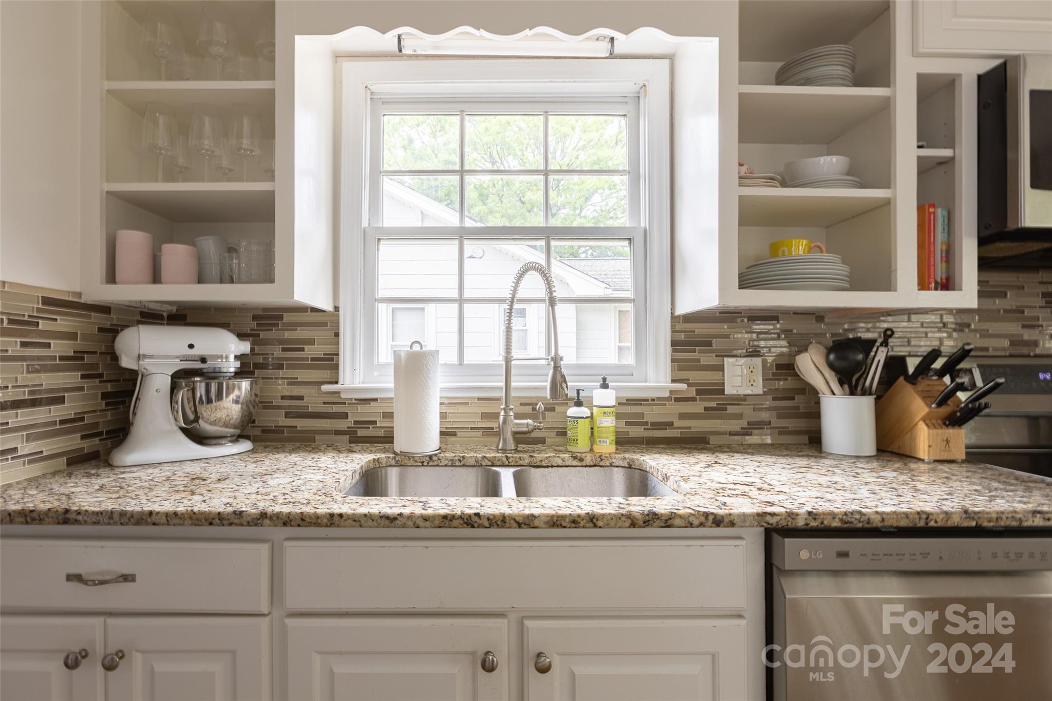 1624 Club Road Charlotte, NC 28205 - Photo 10 of 23 a kitchen with granite countertop kitchen island a large window a sink and a counter space
