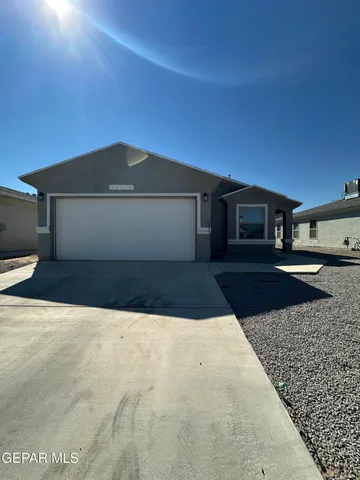 a view of an empty room with closet and windows