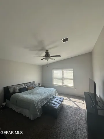 a bedroom with a bed and a night stand