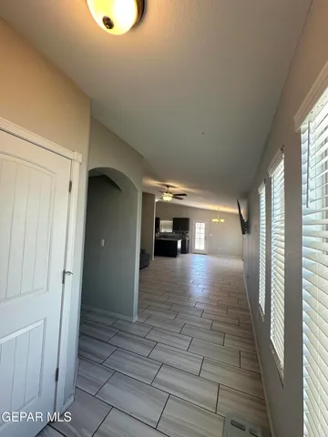 a view of a kitchen with kitchen island stainless steel appliances a sink cabinets and a window