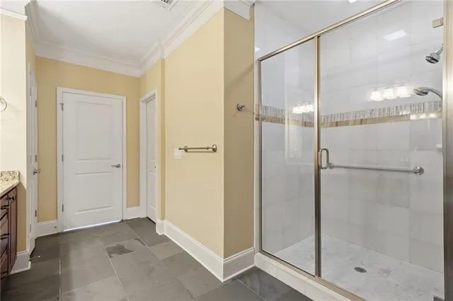 a bedroom with a large bed and a chandelier