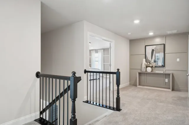 a view of a hallway with livingroom and furniture