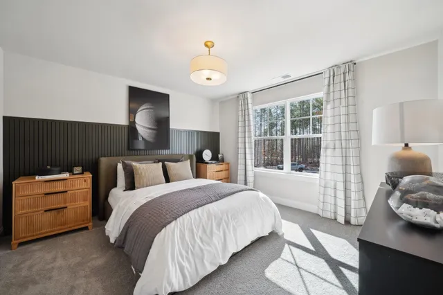 a spacious bedroom with a bed and a window