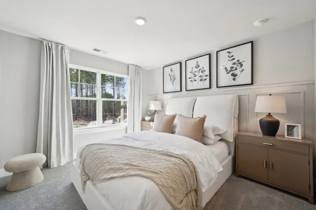 a bedroom with a large bed and a window