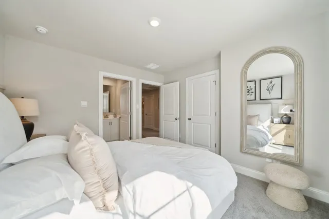 a bedroom with a bed and a view of bathroom