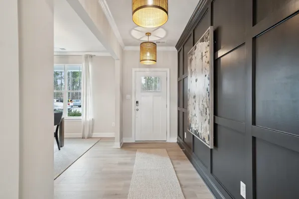 a view of an entryway with wooden floor and mirror
