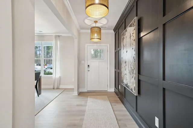 a view of an entryway with wooden floor and mirror