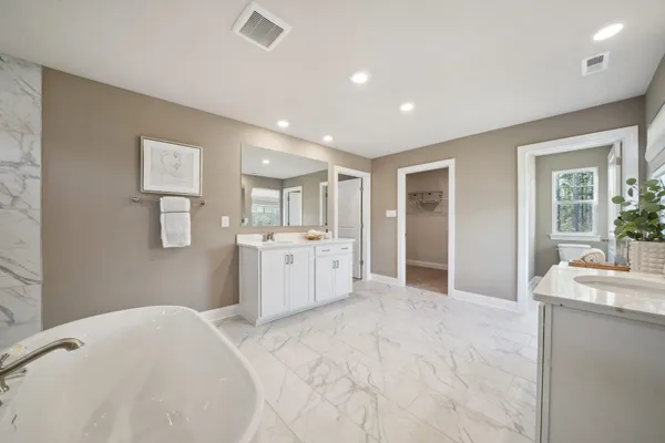 a bathroom with a white tub shower