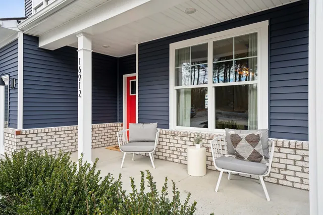 a kitchen with kitchen island granite countertop a sink a counter space appliances and cabinets