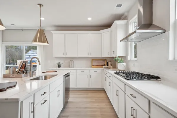 a kitchen with white cabinets and refrigerator