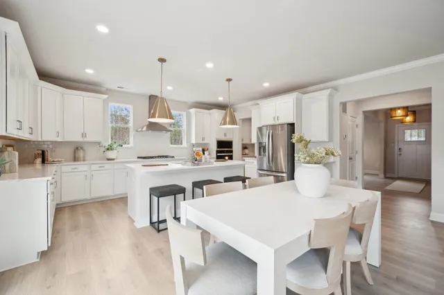 a dining room with a wooden table and chairs