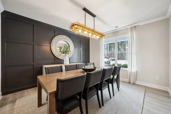 a kitchen with white cabinets and sink