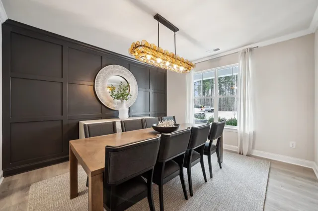a kitchen with white cabinets and sink