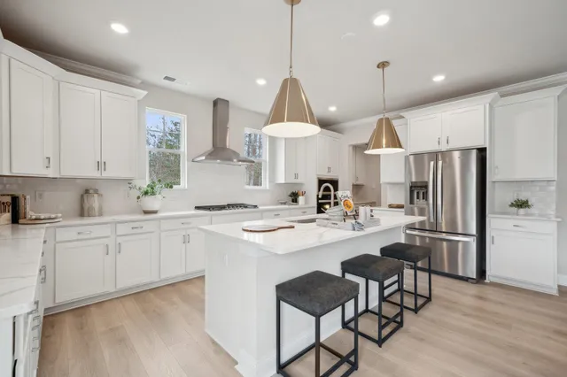 a kitchen with stainless steel appliances a sink stove and refrigerator