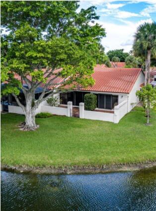 20020 Rima Circle Boca Raton, FL 33434 - Photo 15 of 26 a front view of a house with a garden and trees