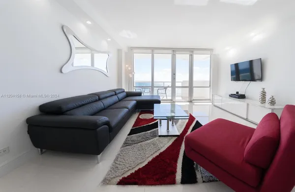 a living room with furniture a flat screen tv and a large window