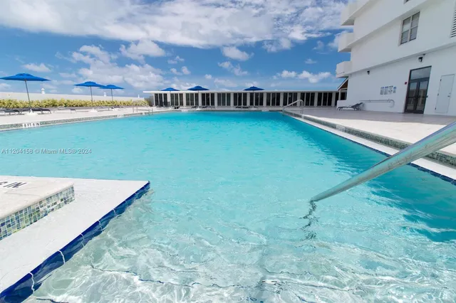 a view of swimming pool with outdoor seating and city view