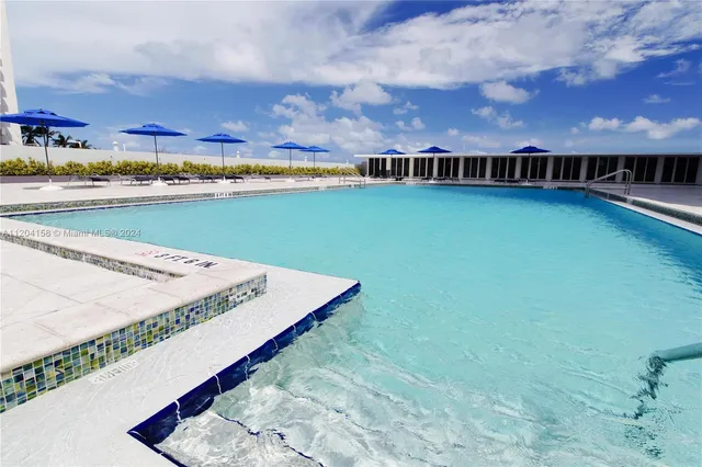 an outdoor space with pool and furniture