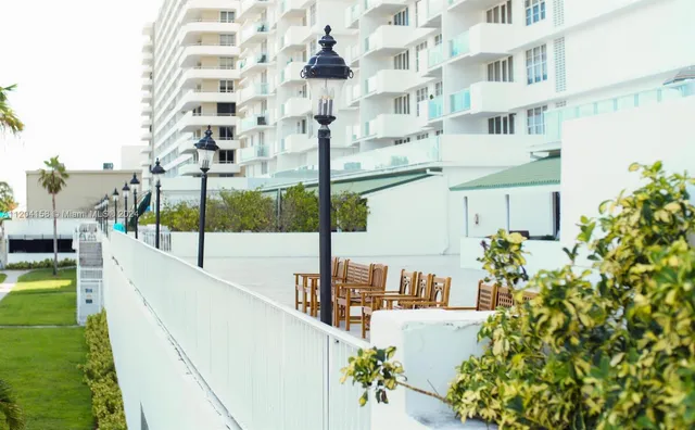 a view of a couches in patio with a yard
