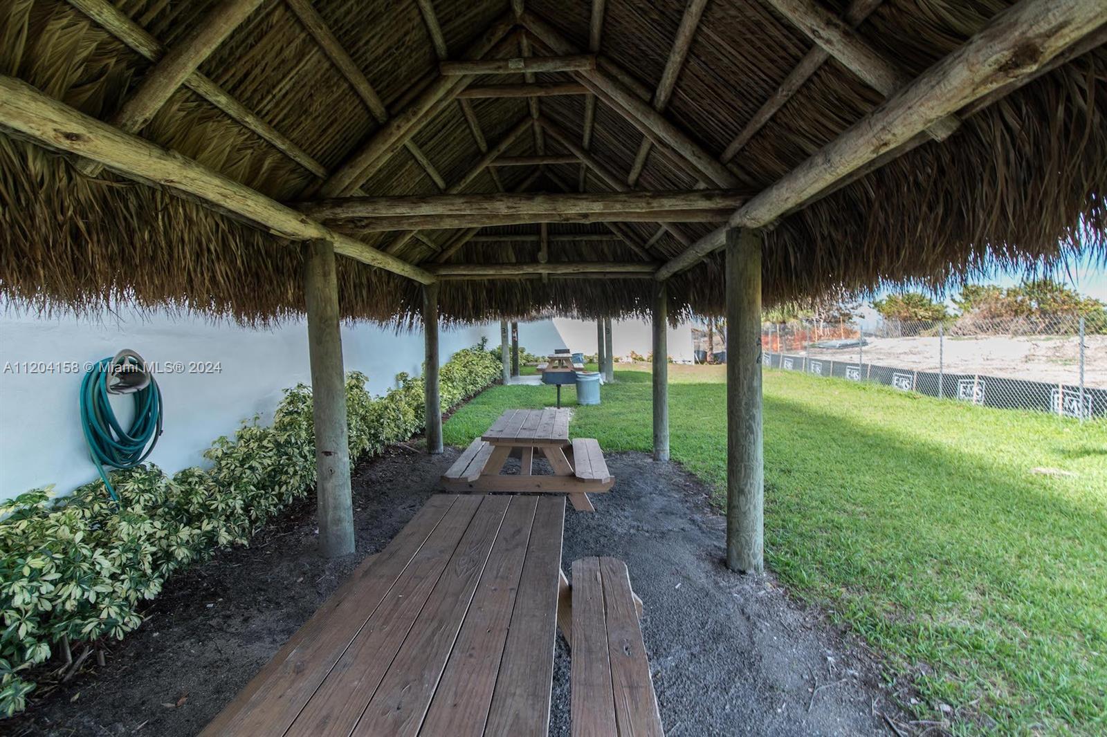 5601 Collins Avenue, Unit 1603 Miami Beach, FL 33140 - Photo 28 of 49 a view of a couches in patio with a yard