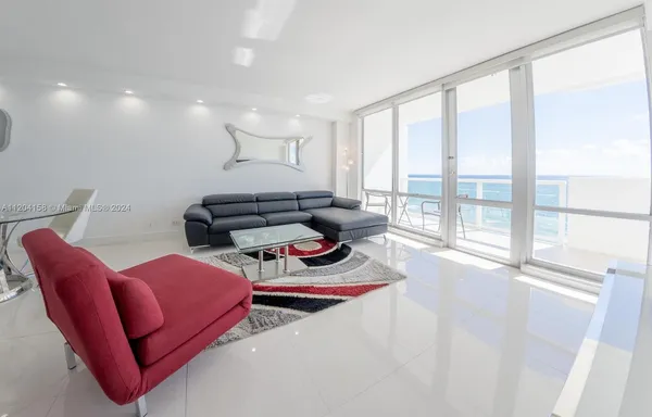 a living room with furniture and a floor to ceiling window