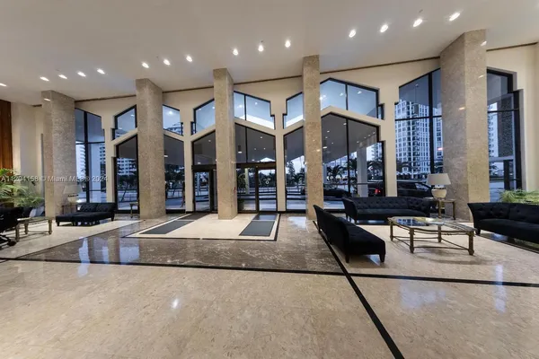 a view of a living room kitchen with stainless steel appliances wooden floor and living room view