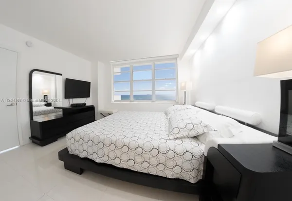 a bedroom with a bed and tv