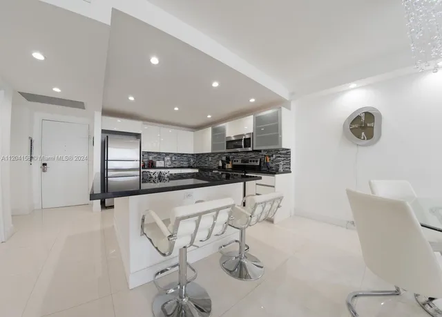a kitchen with stainless steel appliances kitchen island granite countertop a sink and cabinets