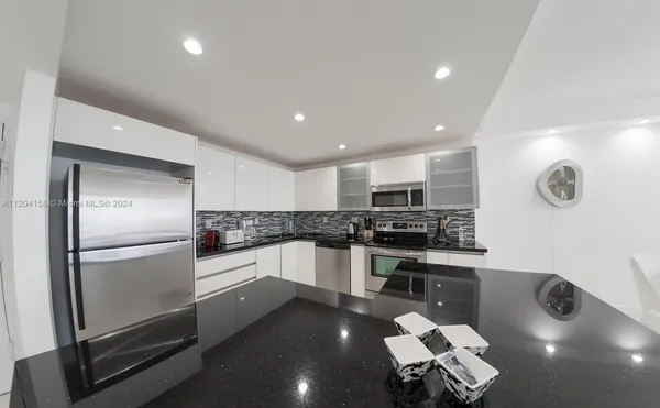 a kitchen with a sink stainless steel appliances and cabinets