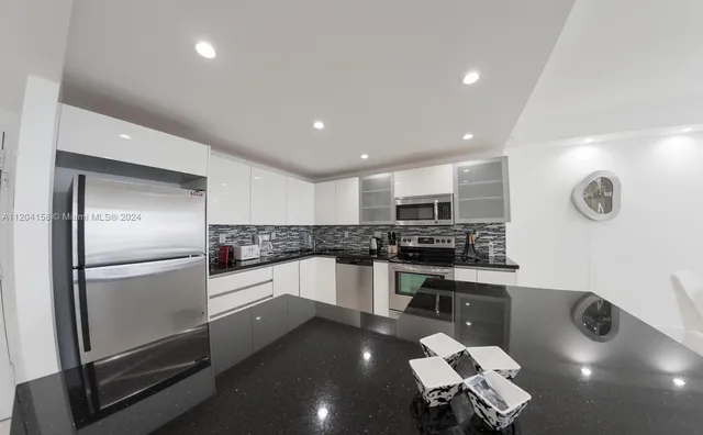 a kitchen with a sink stainless steel appliances and cabinets