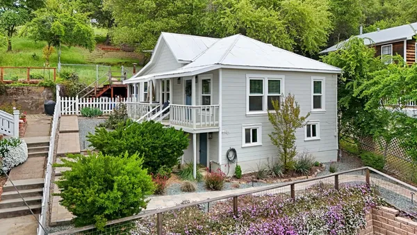 a front view of a house with garden