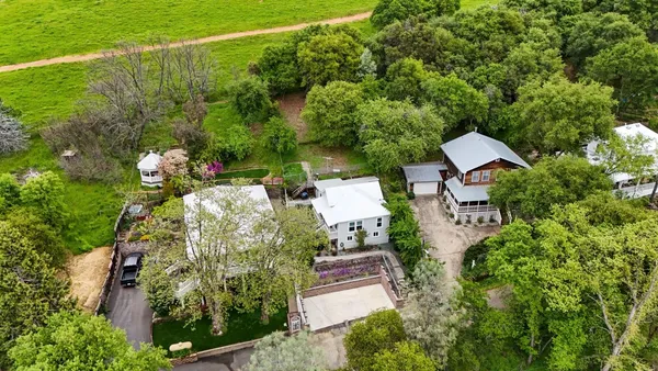 an aerial view of a house with lots of trees