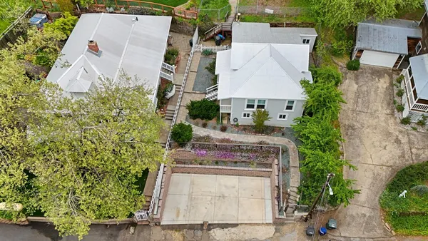 an aerial view of a house with outdoor space