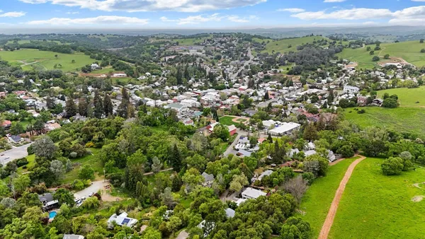 an aerial view of house with yard