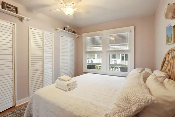 a kitchen with granite countertop white cabinets and window
