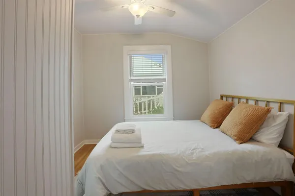 a bedroom with a bed and a mirror