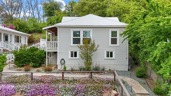 a front view of a house with garden