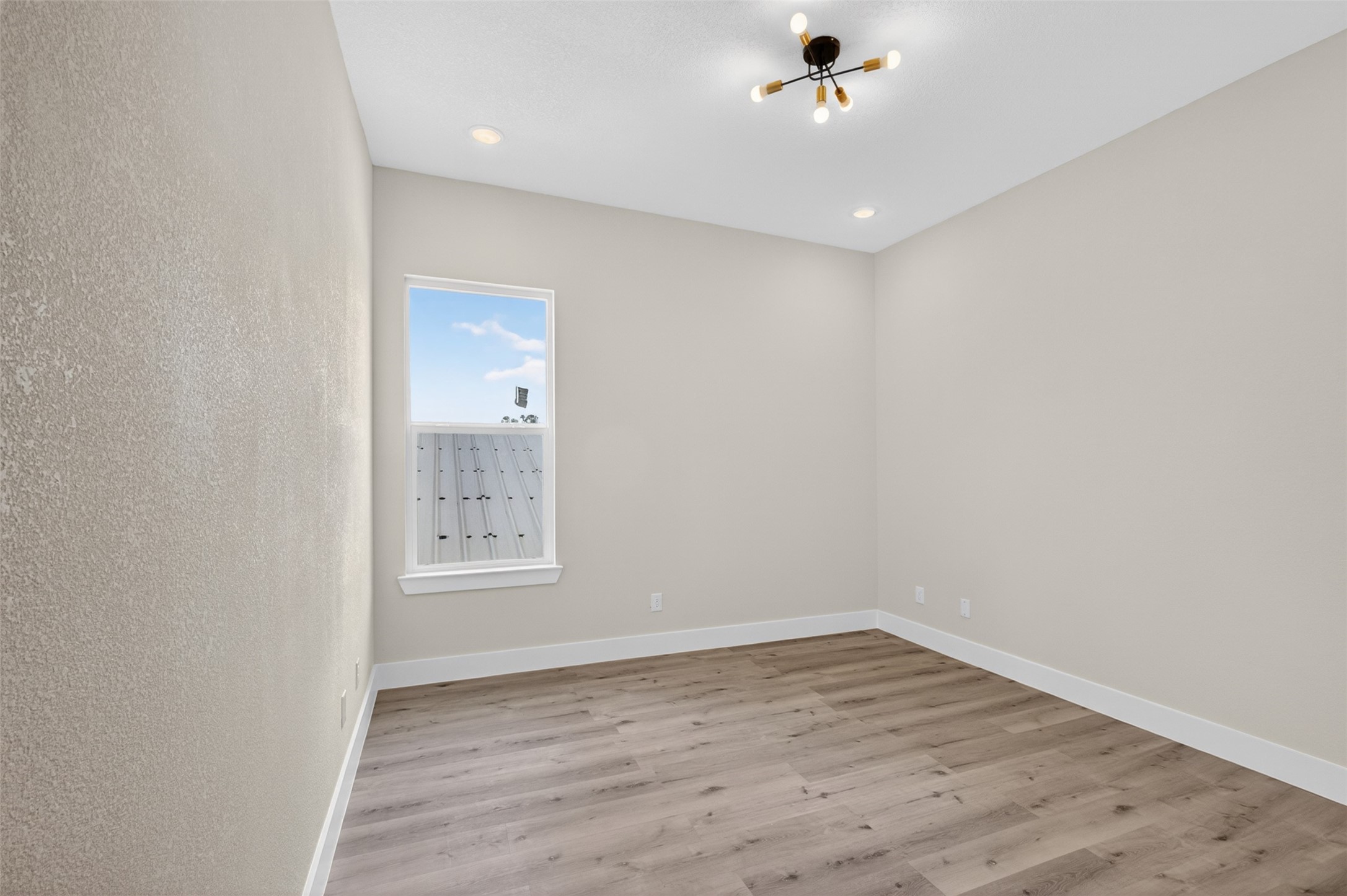 5906 St Augustine Street, Unit F Houston, TX 77021 - Photo 19 of 34 Secondary bedroom with wood-look flooring, recessed lighting, and a window.