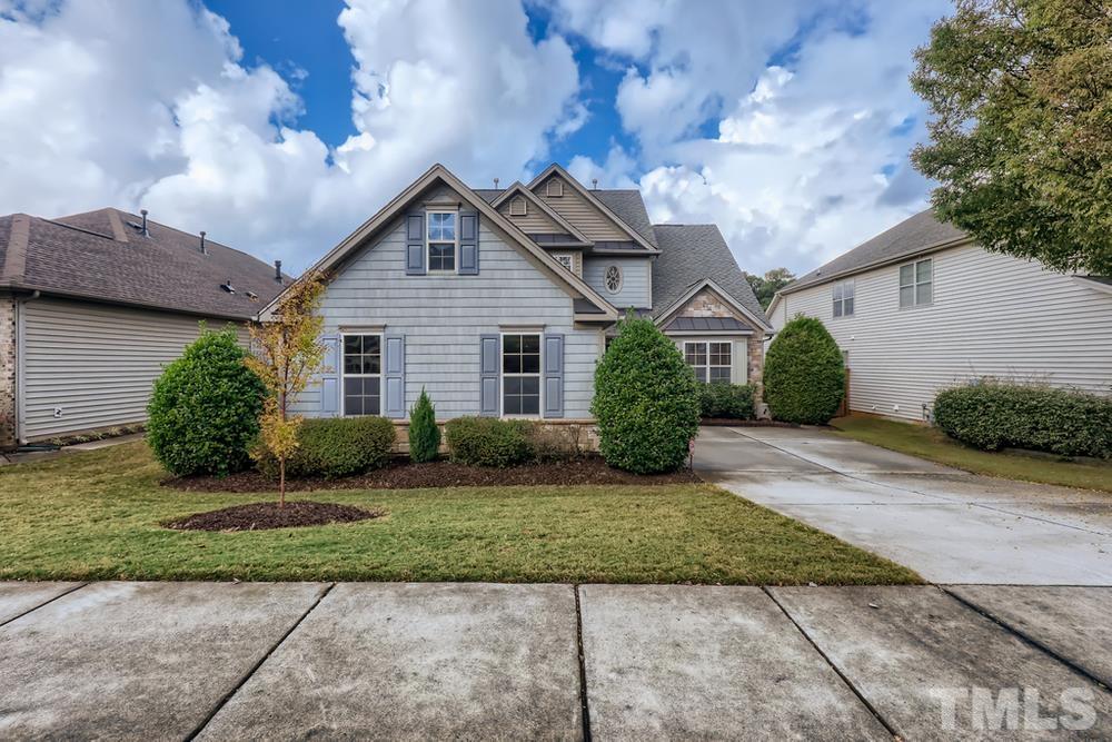 7809 Berry Crest Avenue Raleigh, NC 27617 - Photo 1 of 27 a front view of a house with a yard and garage