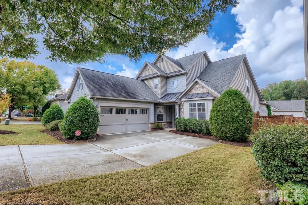 7809 Berry Crest Avenue Raleigh, NC 27617 - Photo 2 of 27 a front view of a house with a yard and garage