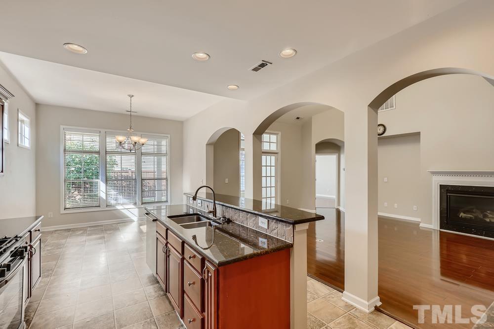 7809 Berry Crest Avenue Raleigh, NC 27617 - Photo 11 of 27 a view of a kitchen with a sink and a large window
