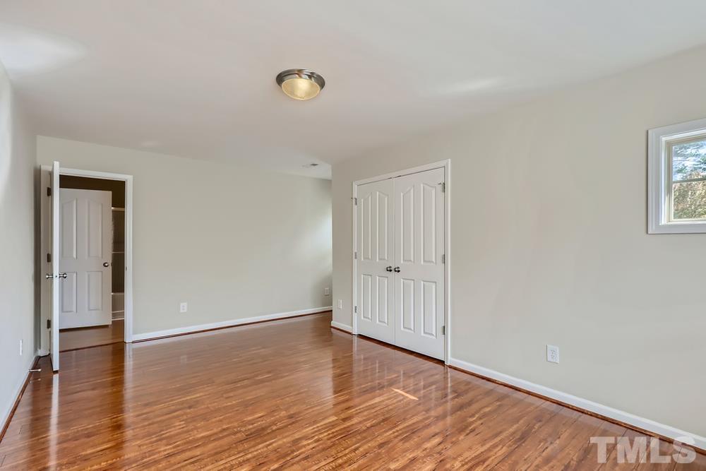 7809 Berry Crest Avenue Raleigh, NC 27617 - Photo 19 of 27 a view of room with wooden floor