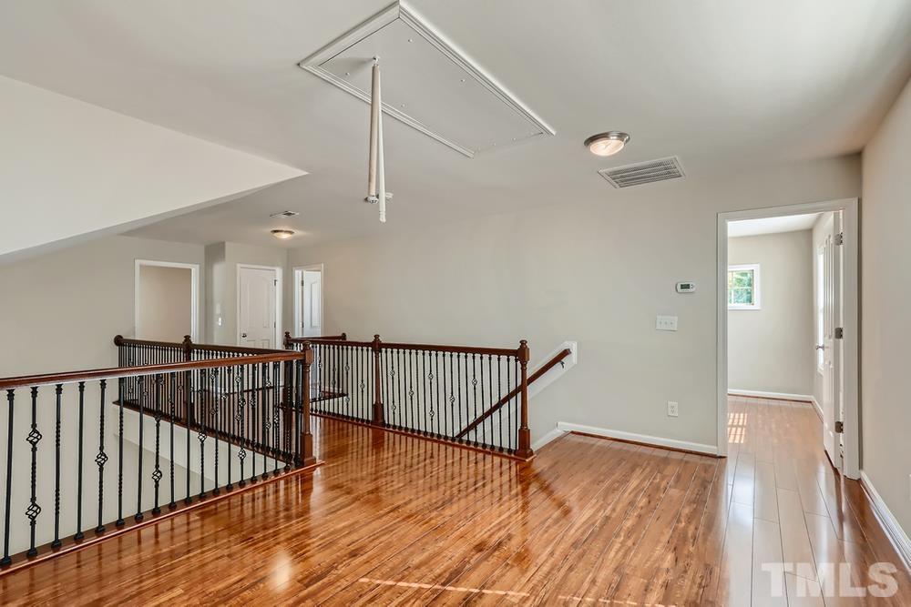 7809 Berry Crest Avenue Raleigh, NC 27617 - Photo 22 of 27 a view of hallway with wooden floor