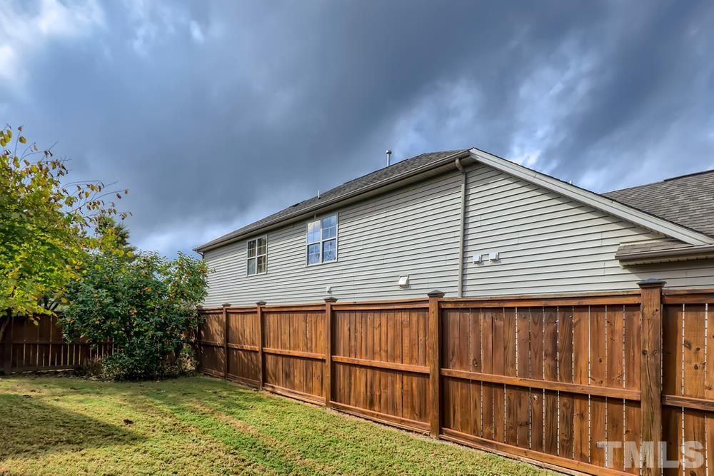 7809 Berry Crest Avenue Raleigh, NC 27617 - Photo 26 of 27 a backyard of a house with lots of green space