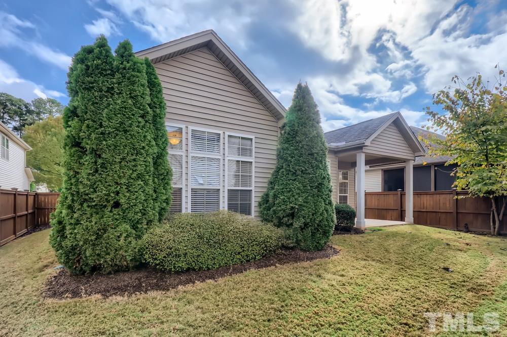 7809 Berry Crest Avenue Raleigh, NC 27617 - Photo 27 of 27 a front view of a house with a yard and garage