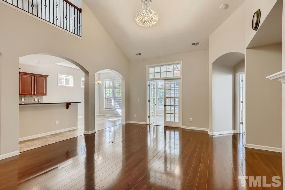 7809 Berry Crest Avenue Raleigh, NC 27617 - Photo 6 of 27 a view of empty room with wooden floor and fan