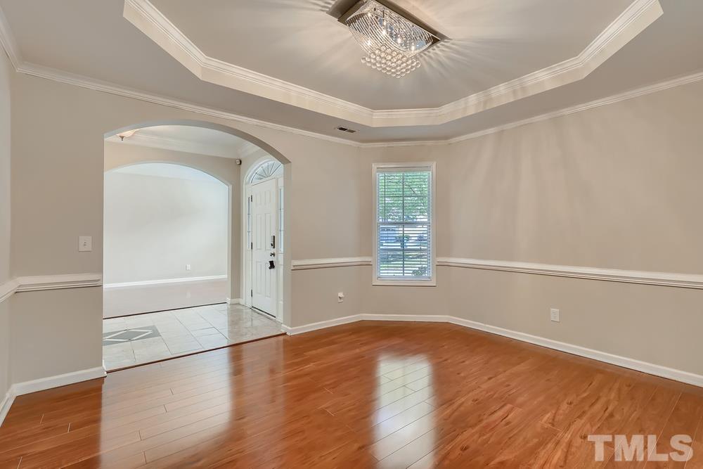 7809 Berry Crest Avenue Raleigh, NC 27617 - Photo 8 of 27 a view of empty room with wooden floor and fan